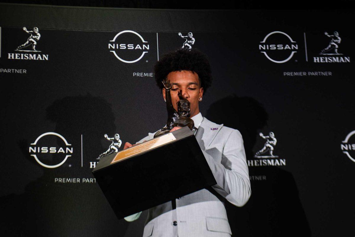 LSU senior quarterback and Heisman winner Jayden Daniels kisses the Heisman trophy on Saturday, Dec. 9, 2023, in New York.