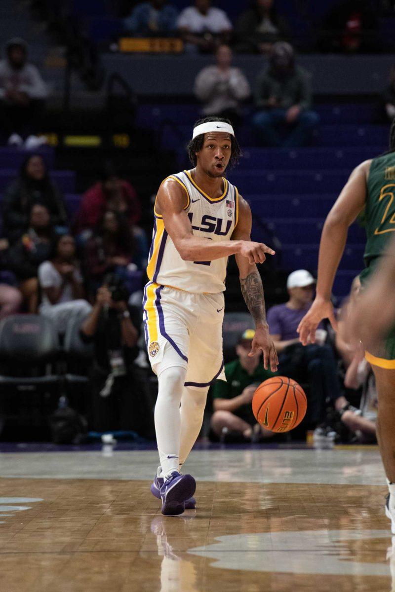 LSU men's basketball freshman guard Mike Williams III (2) points Friday, Dec. 1, 2023, during LSU's 73-66 win against Southeastern Louisiana University at the Pete Maravich Assembly Center in Baton Rouge, La.