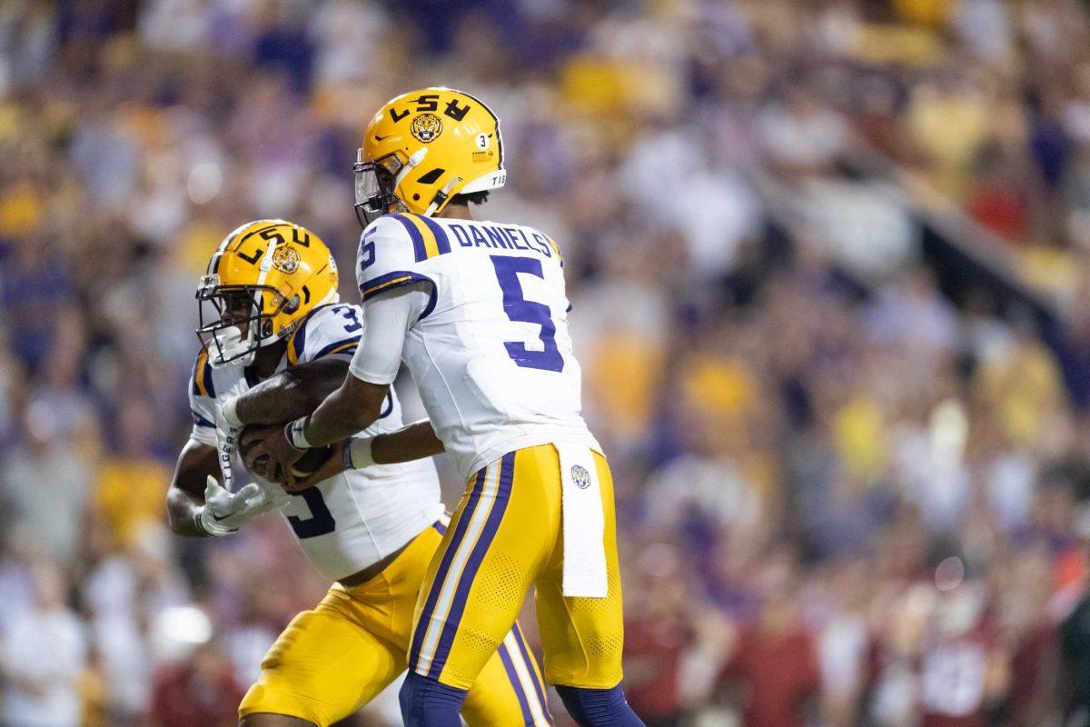 <p>LSU football senior quarterback Jayden Daniels (5) passes the ball Saturday, Sept. 23, 2023, during LSU's 34-31 win against Arkansas at Tiger Stadium in Baton Rouge, La.</p>