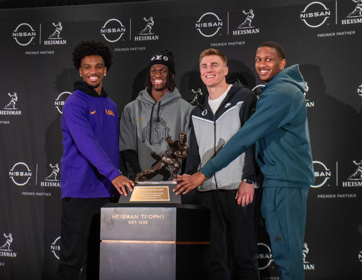 Heisman trophy finalists, from left, LSU quarterback Jayden Daniels, Ohio State wide receiver Marvin Harrison Jr., Oregon quarterback Bo Nix and Washington quarterback Michael Penix Jr. stand for a photo with the Heisman Trophy on Friday, Dec. 8, 2023, in New York.