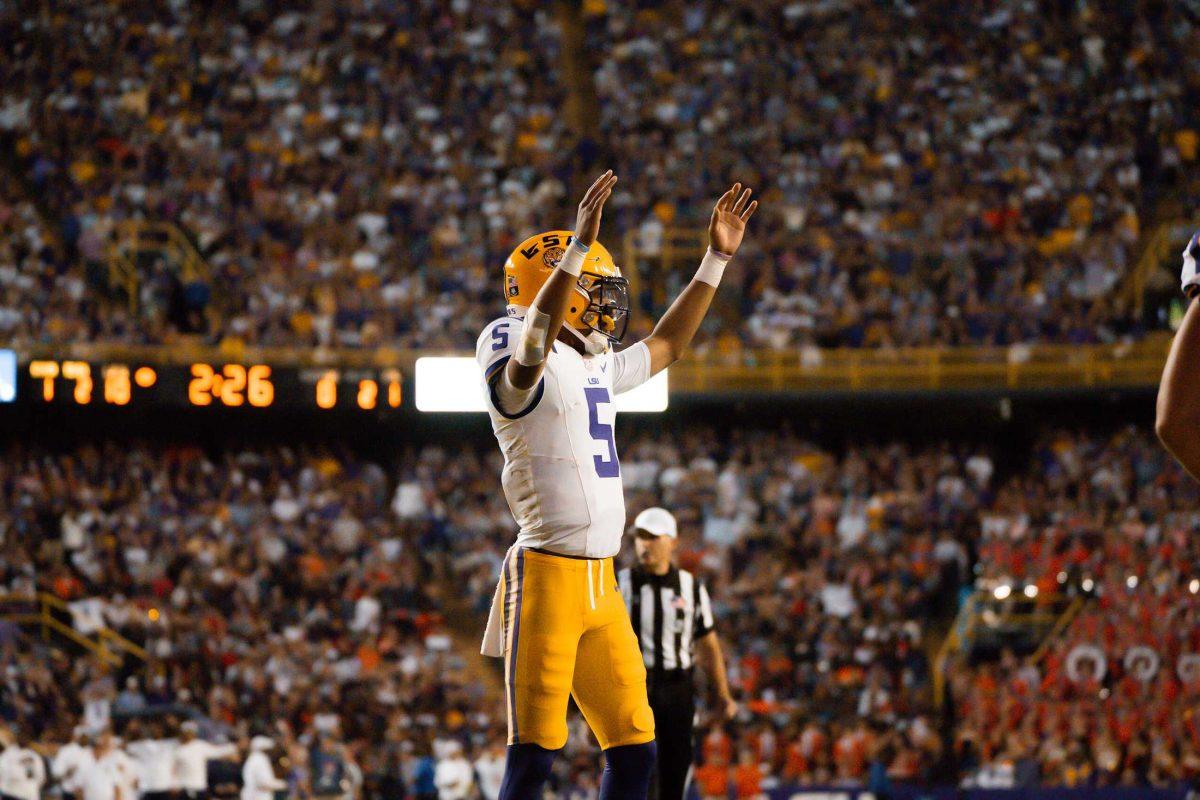 LSU football senior quarterback Jayden Daniels (5) raises his hands during the 48-18 LSU win vs. Auburn on Saturday, Oct. 14, 2023, at Tiger Stadium in Baton Rouge, La.