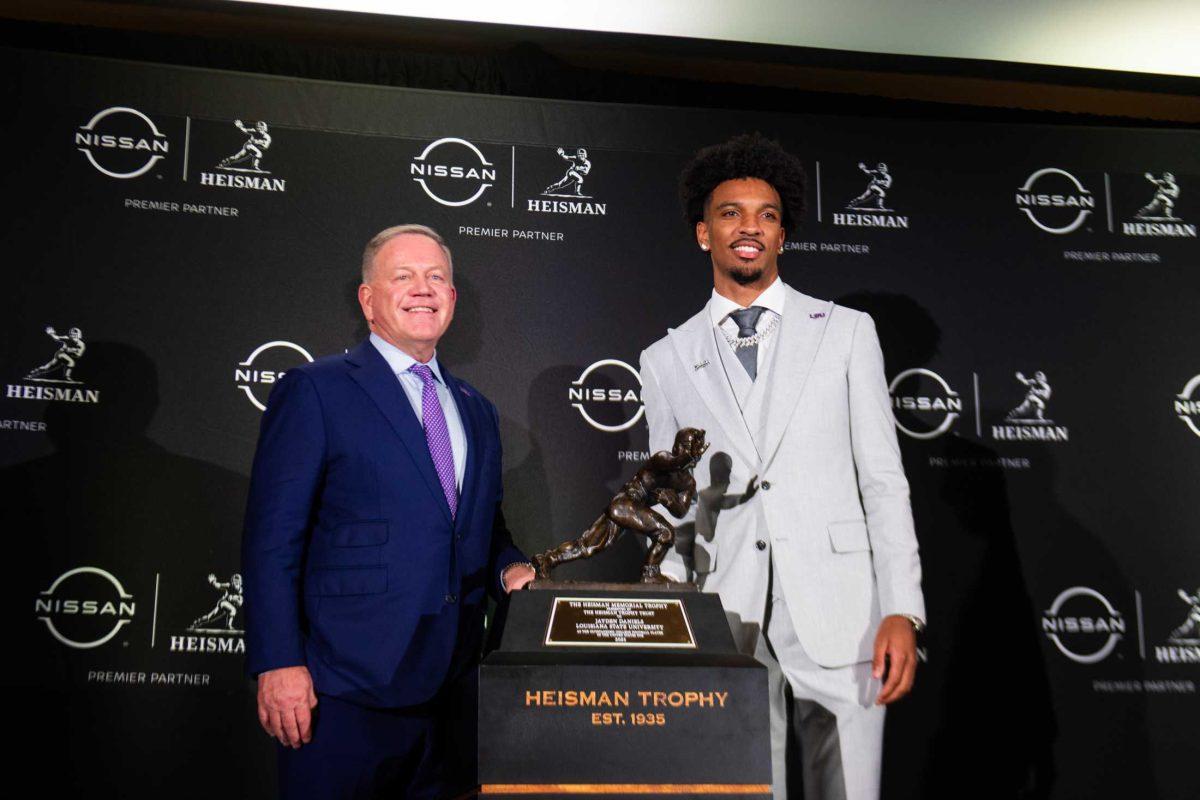 LSU senior quarterback and Heisman trophy winner Jayden Daniels stands with head coach Brian Kelly on Saturday, Dec. 9, 2023, in New York.