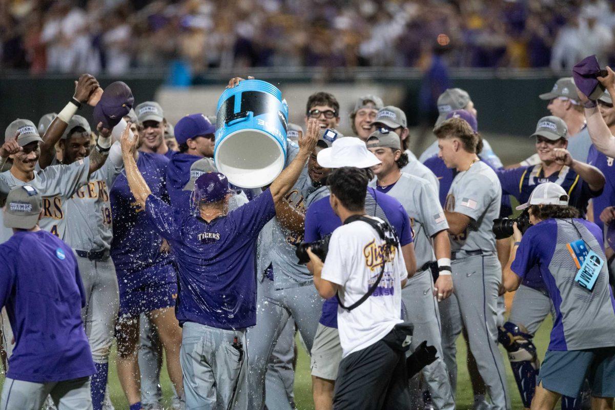 LSU baseball junior pitcher Christian Little (99) pours water on head coach Jay Johnson Sunday, June 11, 2023, after LSU&#8217;s 8-3 win against Kentucky at Alex Box Stadium in Baton Rouge, La.