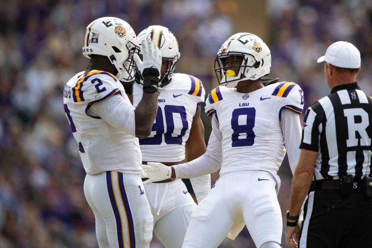 LSU football junior safety Major Burns (8) and senior defensive end Ovie Oghoufo (2) celebrate Saturday, Nov. 25, 2023, during LSU's game against Texas A&amp;M at Tiger Stadium in Baton Rouge, La.