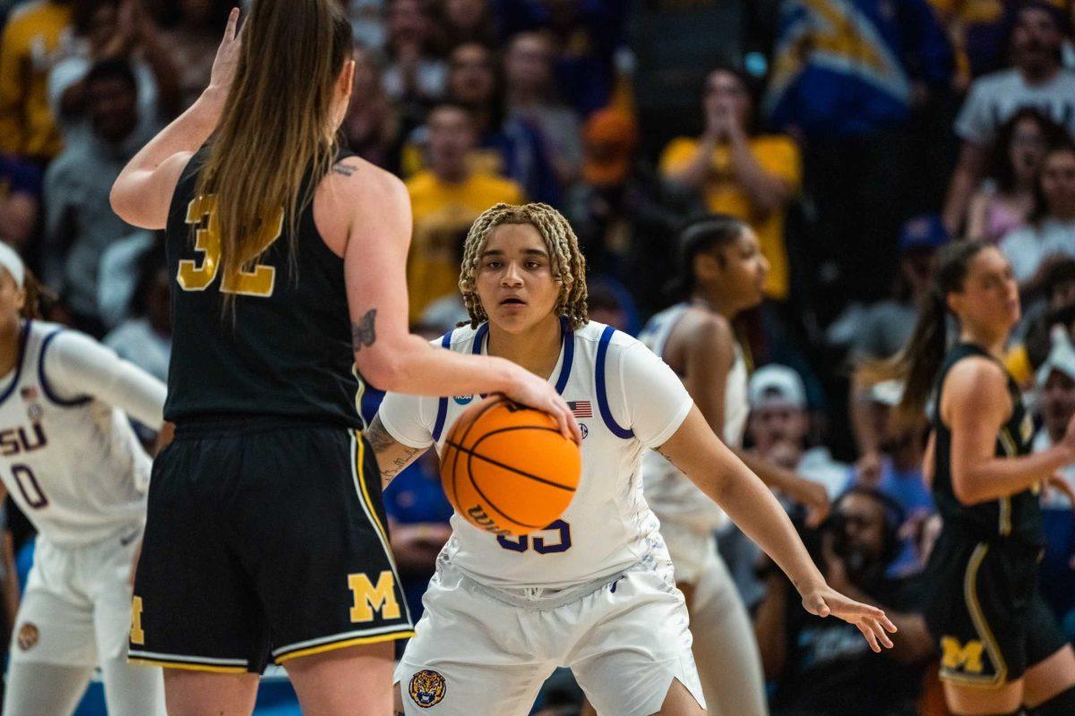 LSU women's basketball sophomore guard Kateri Poole (55) guards a Michigan player during their 66-42 win against Michigan in the second round of March Madness Sunday, March 19, 2023, at the Pete Maravich Assembly Center on N. Stadium Drive in Baton Rouge, La.