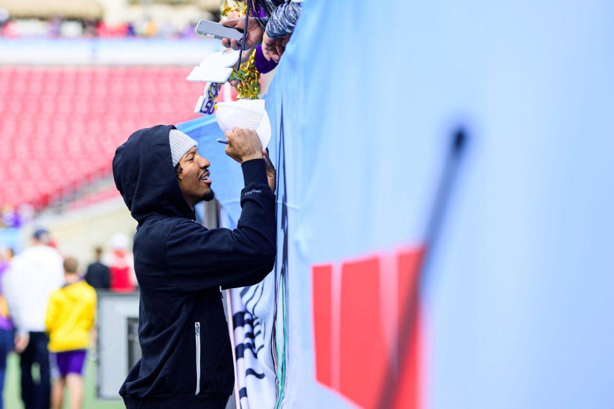 LSU football senior quarterback Jayden Daniels signs autographs on Monday, Jan. 1, 2024, before LSU's 35-31 victory against Wisconsin in Raymond James Stadium in Tampa, Fl.