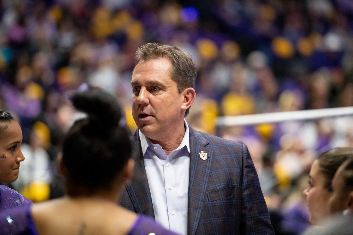 LSU gymnastics head coach Jay Clark talks to the team Friday, Jan. 5, 2024, during LSU&#8217;s 196.975-196.775 victory over Ohio State in the Pete Maravich Assembly Center in Baton Rouge, La.