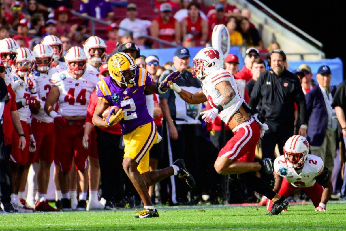 LSU football senior wide receiver Kyren Lacy (2) runs from his defender on Monday, Jan. 1, 2024, during LSU's 35-31 victory against Wisconsin in Raymond James Stadium in Tampa, Fl.