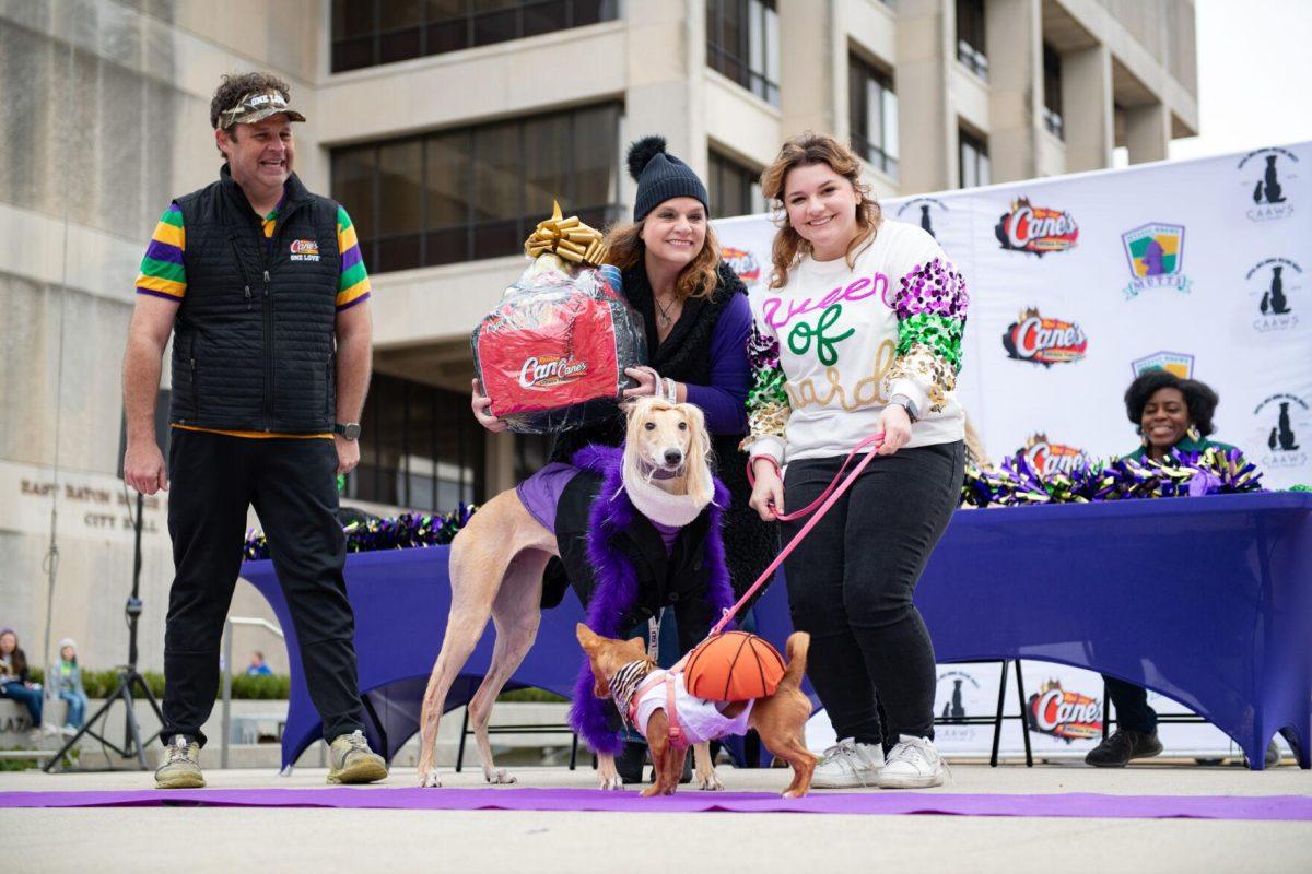 First place group costume winners pose with their prize Sunday, Jan. 28, 2024, during CAAWS' Mystic Krewe of Mutts costume contest in downtown Baton Rouge, La.