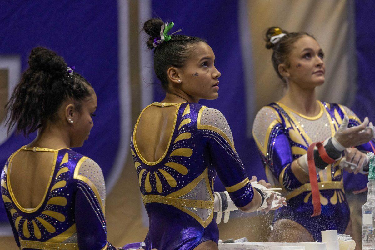 LSU gymnastics all-around senior Haleigh Bryant chalks her hands Friday, Jan. 19, 2024, during LSU&#8216;s 198.125 - 197.600 victory over the University of Kentucky in the Pete Maravich Assembly Center.