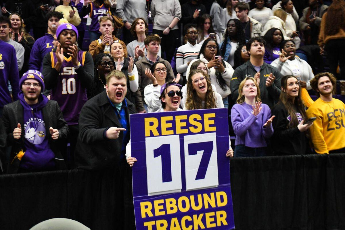 LSU women&#8217;s basketball fans cheer and hold up a &#8220;Reese Rebound Tracker&#8221; sign Sunday, Jan. 21, 2024, during LSU&#8217;s 99-68 win over Arkansas in the Pete Maravich Assembly Center in Baton Rouge, La.