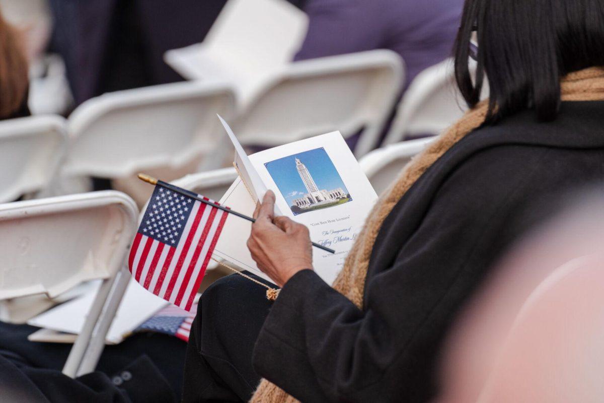 A person flips through the Inauguration program Sunday, Jan. 7, 2024, prior to the inauguration ceremony beginning in Baton Rouge, La.