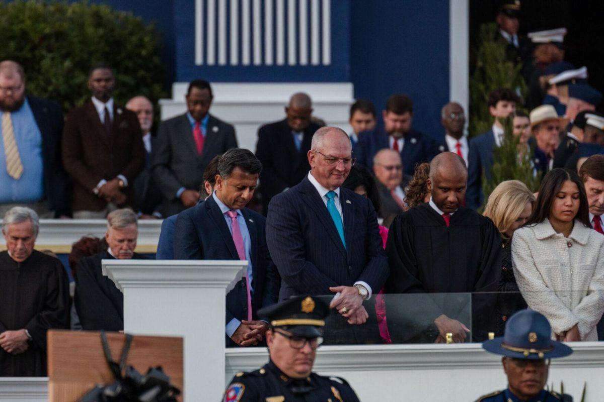 Former Governors Bobby Jindal and John Bel Edwards stand Sunday, Jan. 7, 2024, during the inauguration ceremony in Baton Rouge, La.