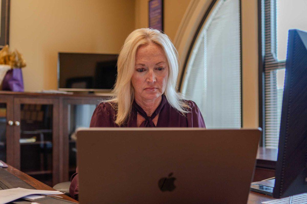 Manship School Dean Kimberly Bissell works on her laptop on Wednesday, Nov. 8, 2023, inside her office in the Journalism Building on LSU's campus.