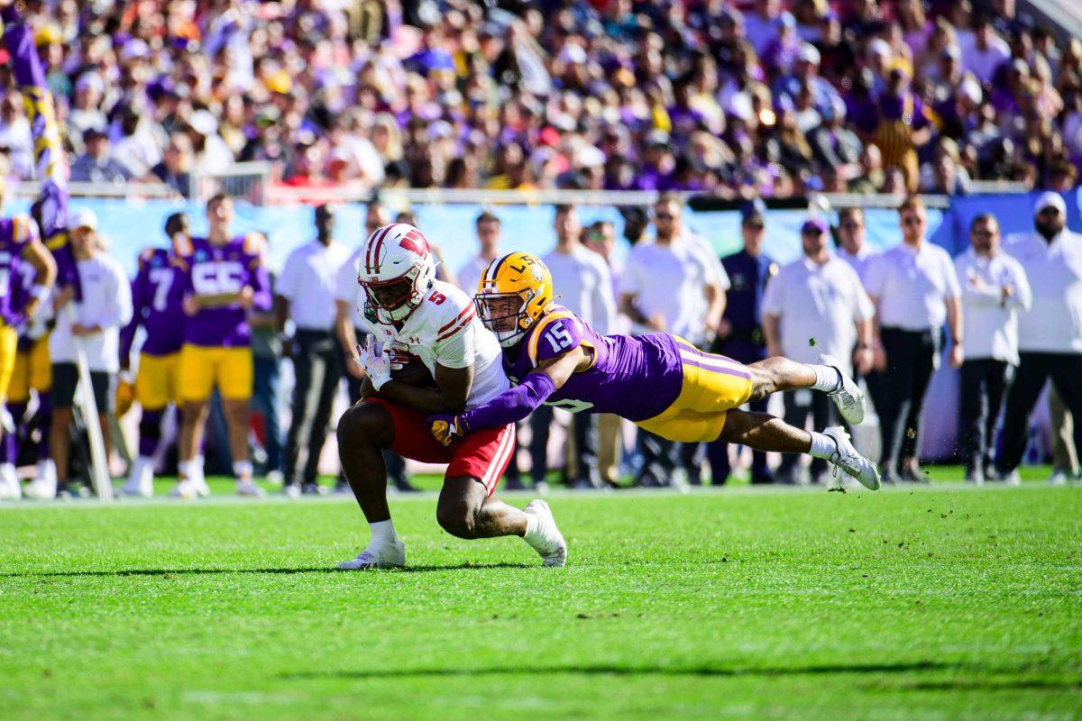 LSU football redshirt sophomore safety Sage Ryan (15) makes a tackle on Monday, Jan. 1, 2024, during LSU's 35-31 victory against Wisconsin in Raymond James Stadium in Tampa, Fl.