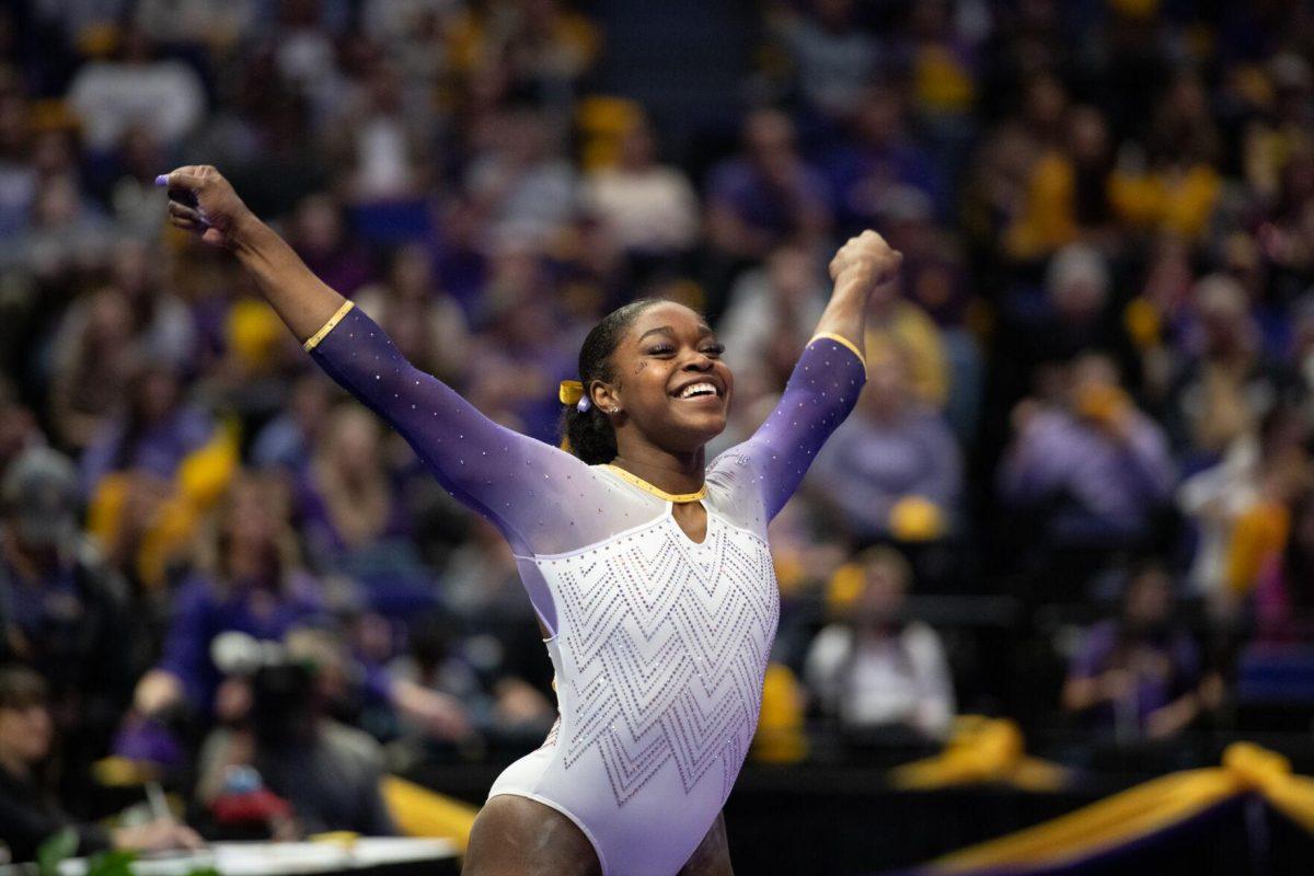 LSU gymnastics all-around graduate student Kiya Johnson smiles during her routine Friday, Feb. 2, 2024, during LSU&#8217;s 198.475-196.200 win against Arkansas at the Pete Maravich Assembly Center in Baton Rouge, La.