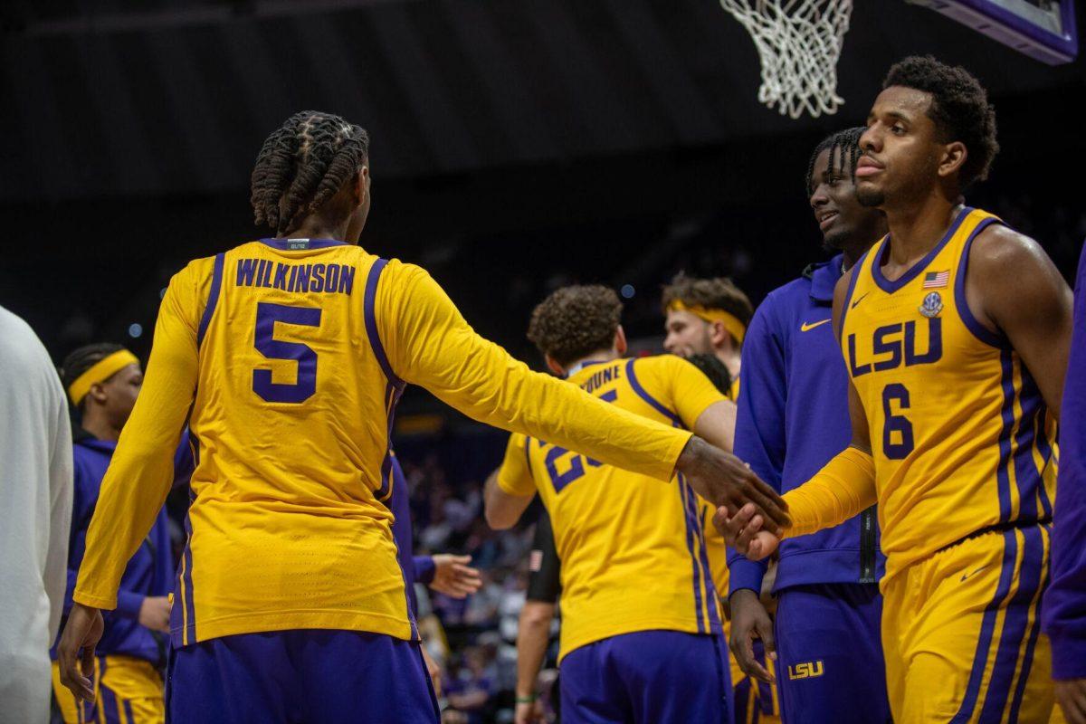 LSU men's Basketball senior forward Mwani Wilkinson (5) shakes hands with graduate student guard Jordan Wright (6) on Saturday, Feb. 3, 2024, during LSU's 94-74 win against Arkansas in the Pete Maravich Assembly Center in Baton Rouge, La.