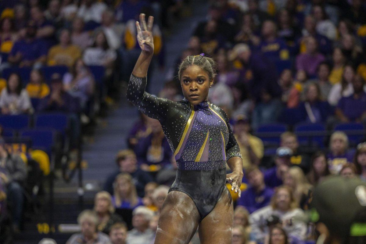 LSU gymnastics fifth-year senior all-around Kiya Johnson strikes a pose during her balance beam routine Friday, Feb. 16, 2024, during LSU's win 198.300-197.10 against Auburn in the Pete Maravich Assembly Center.