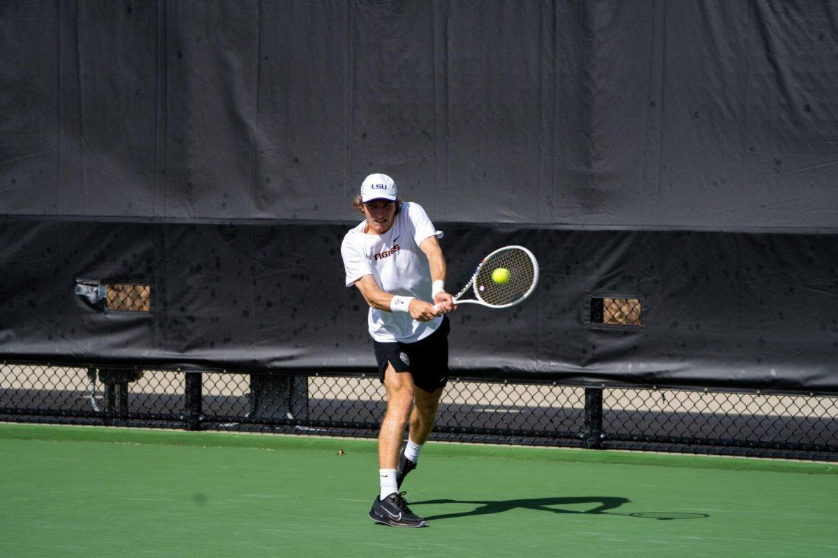 LSU men's tennis 5th-year senior George Stoupe hits a backhand during his 6-3, 3-6, 6-1 singles win against Rice Sunday, Feb. 4, 2023 at the LSU Tennis Complex on Gourrier Avenue in Baton Rouge, La.