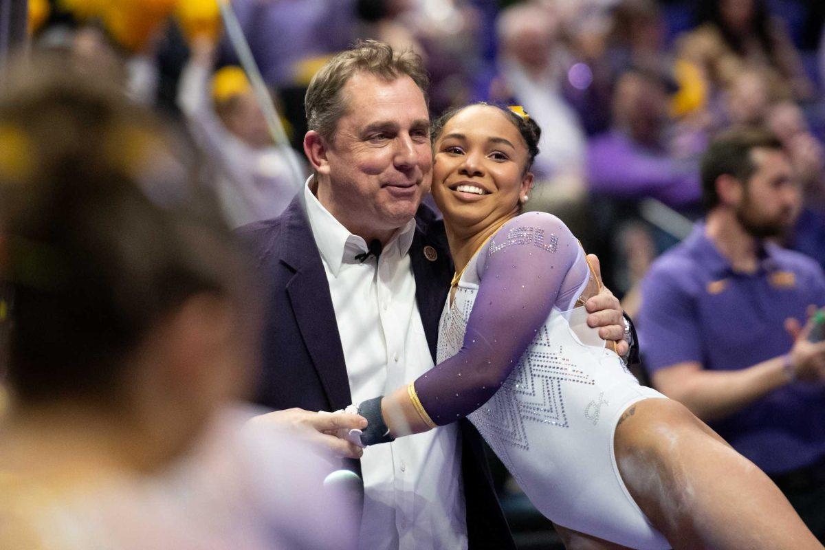 LSU gymnastics all-around freshman Konnor McClain hugs head coach Jay Clark Friday, Feb. 2, 2024, during LSU&#8217;s&#160;198.475-196.200 win&#160;against Arkansas at the Pete Maravich Assembly Center in Baton Rouge, La.