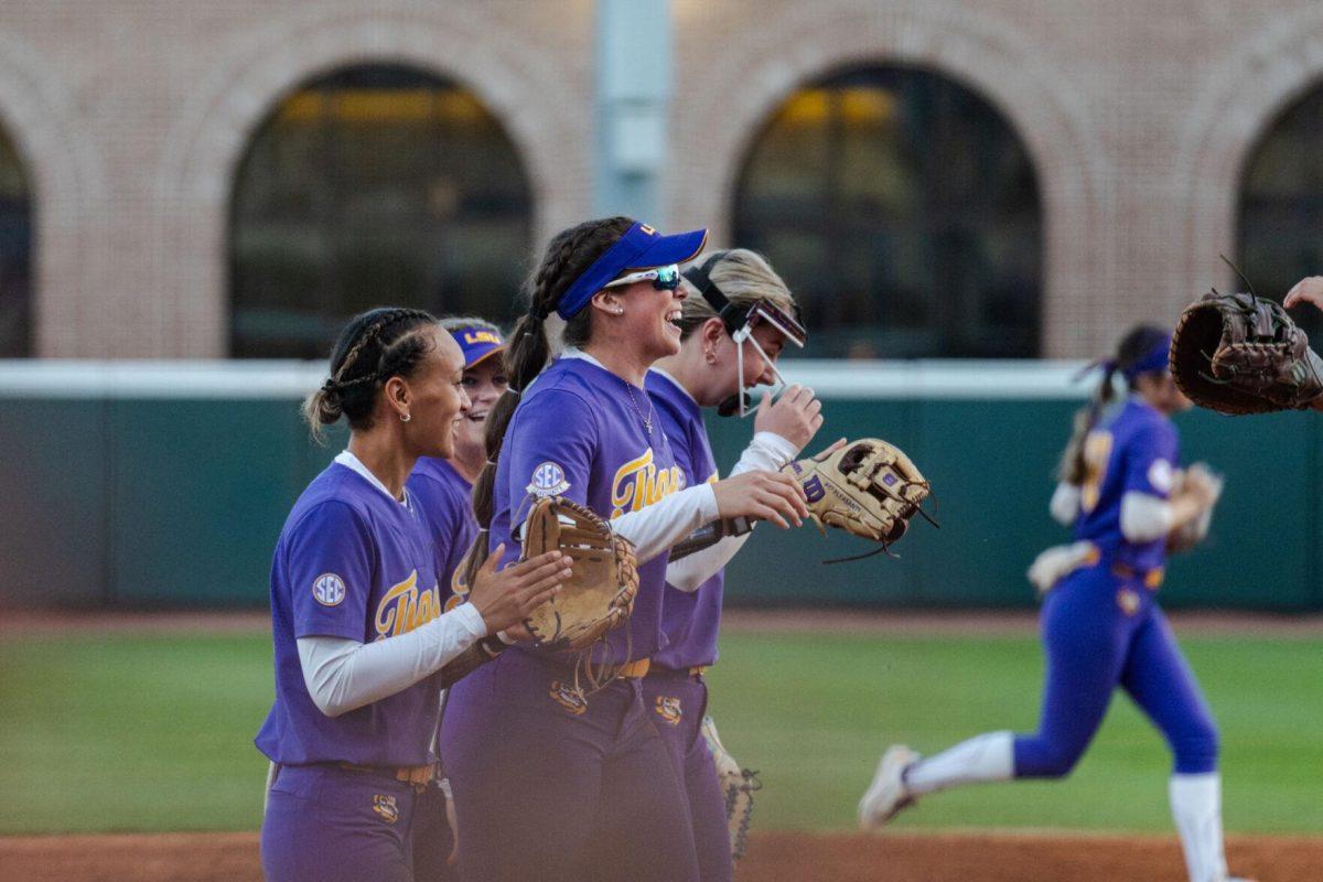 The LSU softball team celebrates graduate student infielder Taylor Pleasants' (17) diving catch Friday, Feb. 23, 2024, during LSU&#8217;s 8-5 win over Boise State at Tiger Park in Baton Rouge, La.