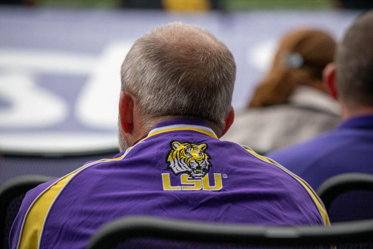 A fan watches the LSU baseball game during LSU's 11-8 win against VMI on Friday, Feb. 16, 2024, at Alex Box Stadium in Baton Rouge, La.