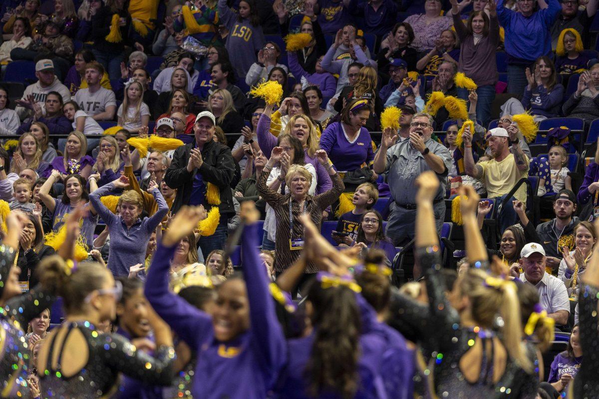 Former LSU gymnastics head coach D-D Breaux celebrates fifth-year all-around Kiya Johnson's balance beam routine Friday, Feb. 16, 2024, during LSU's win 198.300-197.10 against Auburn in the Pete Maravich Assembly Center.