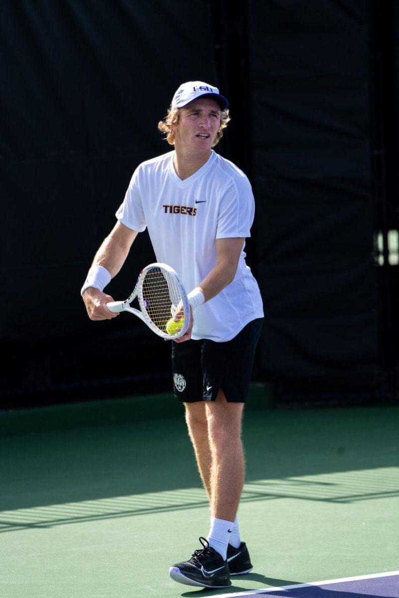 LSU men's tennis 5th-year senior George Stoupe serves during his 6-3, 3-6, 6-1 singles win against Rice Sunday, Feb. 4, 2023 at the LSU Tennis Complex on Gourrier Avenue in Baton Rouge, La.