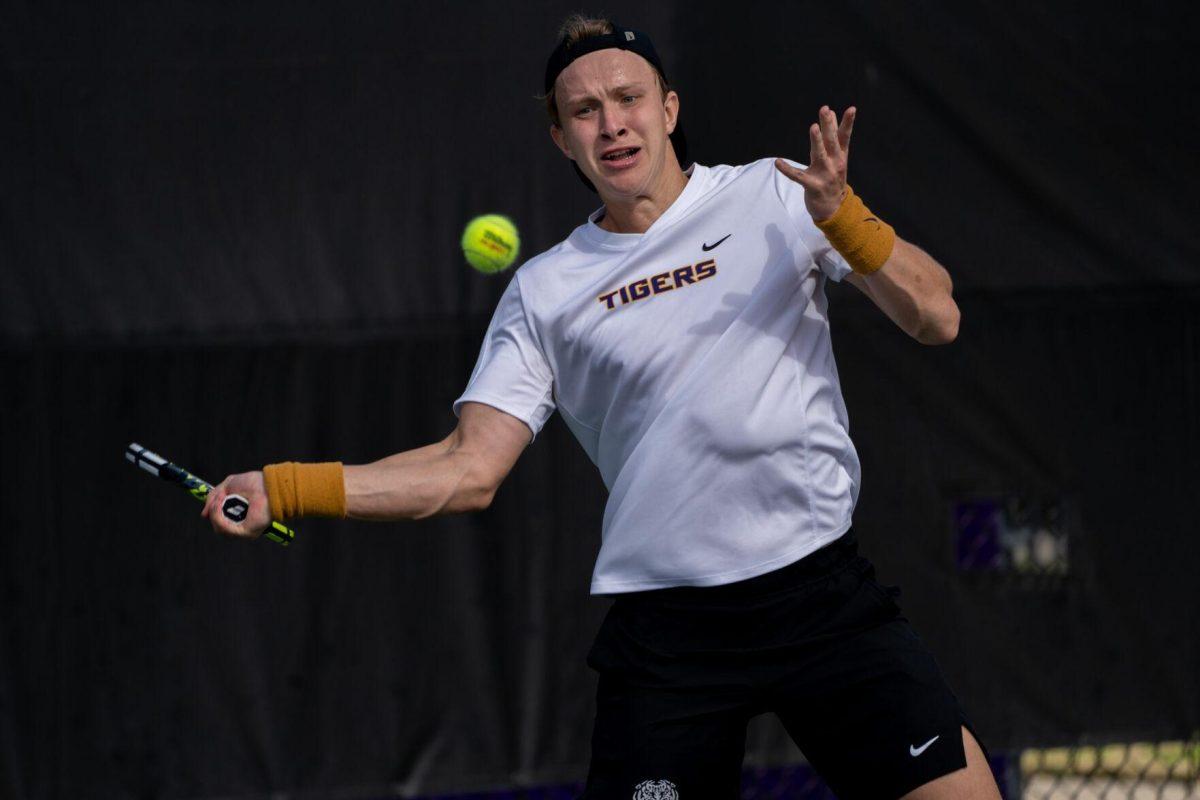 LSU men's tennis junior Julien Penzlin hits a forehand during his 7-6, 6-3 singles win against Rice Sunday, Feb. 4, 2023 at the LSU Tennis Complex on Gourrier Avenue in Baton Rouge, La.