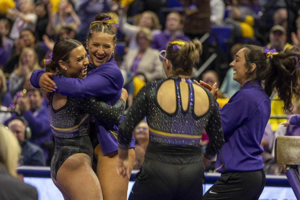 LSU gymnastics junior all-around celebrates a successful balance beam routine with her teammates Friday, Feb. 16, 2024, during LSU's win 198.300-197.10 against Auburn in the Pete Maravich Assembly Center.