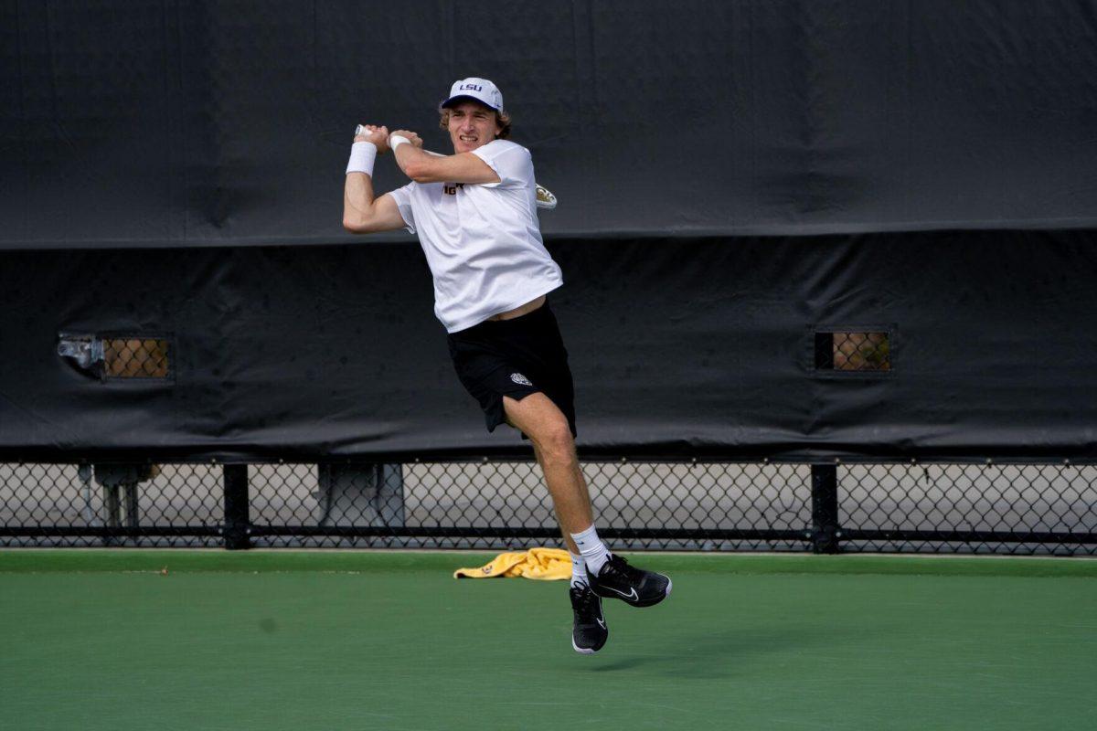 LSU men's tennis 5th-year senior George Stoupe hits a backhand during his 6-3, 3-6, 6-1 singles win against Rice Sunday, Feb. 4, 2023 at the LSU Tennis Complex on Gourrier Avenue in Baton Rouge, La.