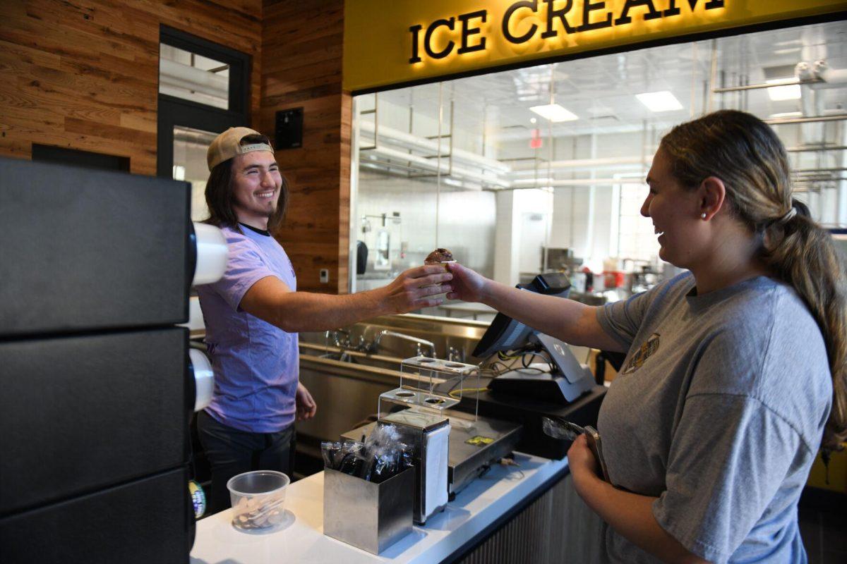 LSU information systems and decision sciences sophomore Tyler Besse serves a customer at the new Dairy Store location Tuesday, Feb. 20, 2024, on S. Campus Dr. on LSU&#8217;s campus in Baton Rouge, La.