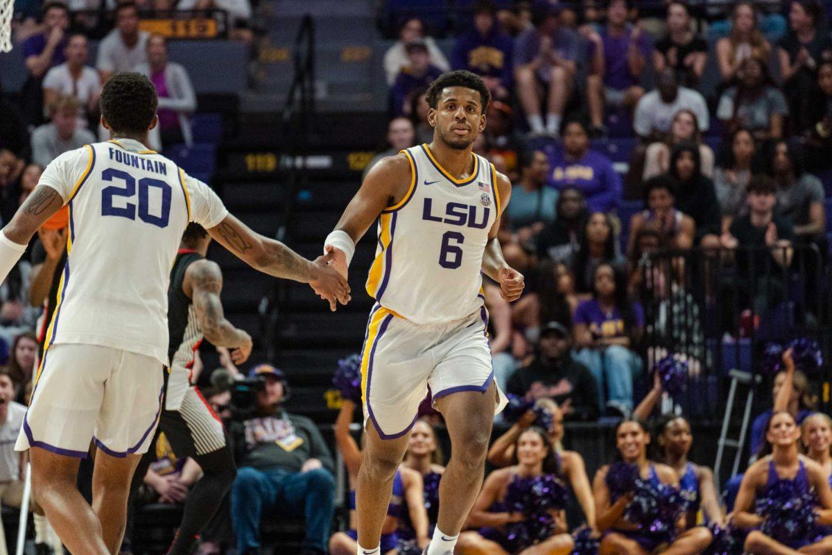 LSU men&#8217;s basketball graduate student guard Jordan Wright (6) high fives senior forward Derek Fountain (20) after scoring Tuesday, Feb. 27, 2024, during LSU&#8217;s 67-66 win against Georgia in the Pete Maravich Assembly Center in Baton Rouge, La.