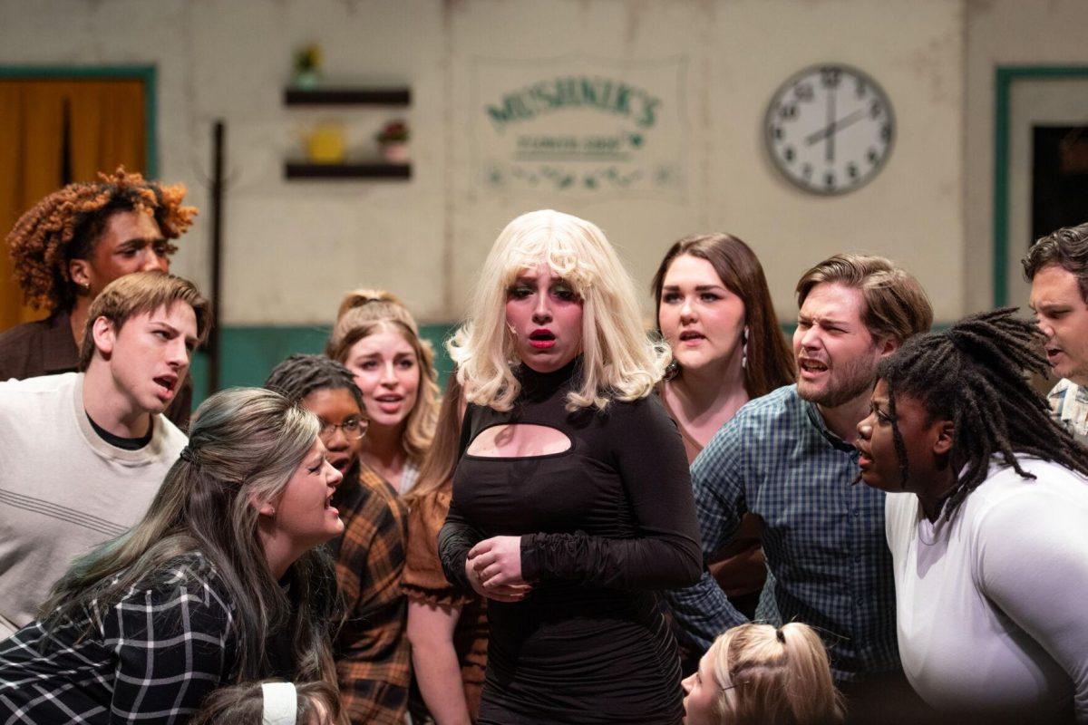 The ensemble surrounds LSU theatre technology and design freshman Kamryn Hecker Thursday, Feb. 1, 2024, during LSU Musical Theatre Club's performance of "Little Shop of Horrors" at the Reilly Theatre in Baton Rouge, La.