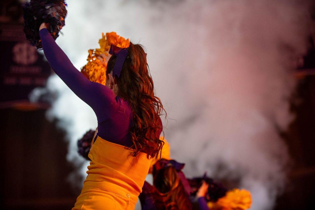 LSU cheerleaders shake their pompoms through the smoke in cheer for the men's basketball team on Saturday, Feb. 3, 2024, before LSU's 94-74 win against Arkansas in the Pete Maravich Assembly Center in Baton Rouge, La.