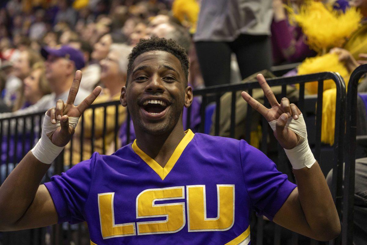 An LSU cheerleader poses for a photo Friday, Feb. 16, 2024, during LSU's win 198.300-197.10 against Auburn in the Pete Maravich Assembly Center.
