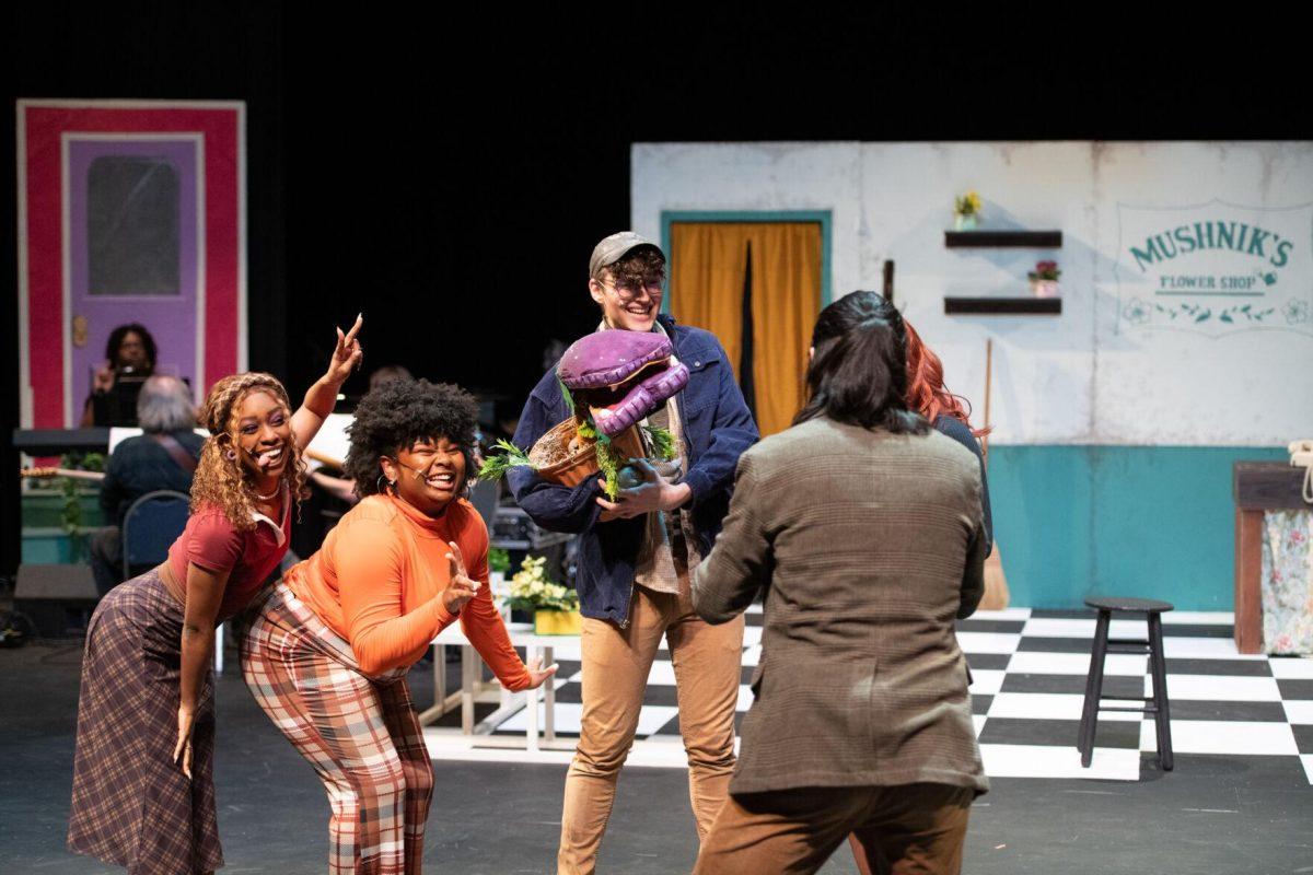 Characters pose for a photo for Mr. Mushnik Thursday, Feb. 1, 2024, during LSU Musical Theatre Club's performance of "Little Shop of Horrors" at the Reilly Theatre in Baton Rouge, La.