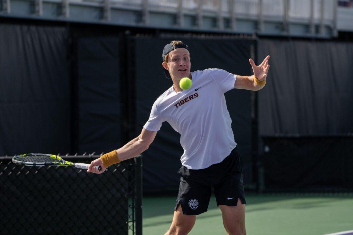 LSU men's tennis junior Julien Penzlin hits a forehand during his 7-6, 6-3 singles win against Rice Sunday, Feb. 4, 2023 at the LSU Tennis Complex on Gourrier Avenue in Baton Rouge, La.