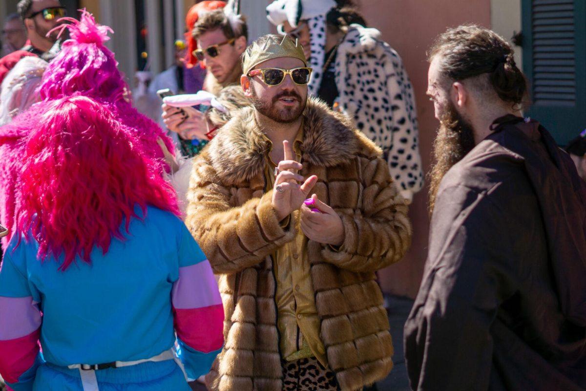 A kingly man discusses Tuesday, Feb. 13, 2024, on Bourbon Street in New Orleans, La.