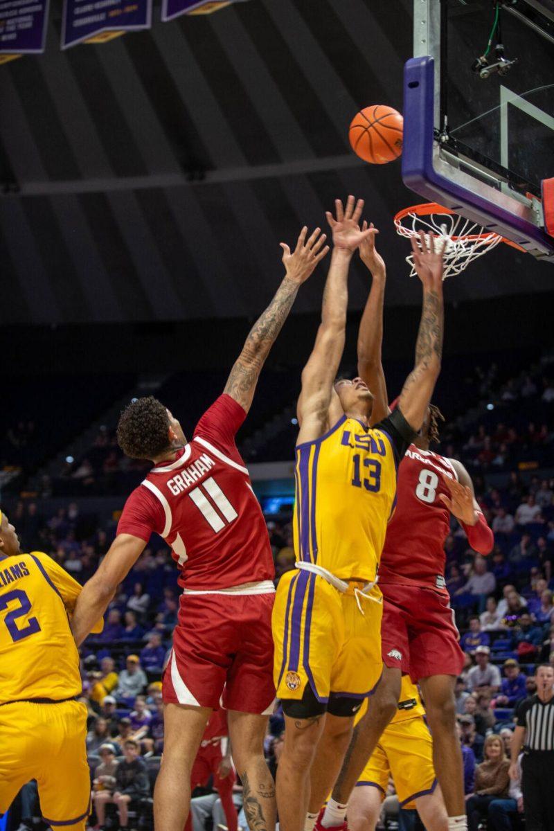 LSU men's basketball sophomore forward Jalen Reed (13) jumps for the ball on Saturday, Feb. 3, 2024, during LSU's 94-74 win against Arkansas in the Pete Maravich Assembly Center in Baton Rouge, La.