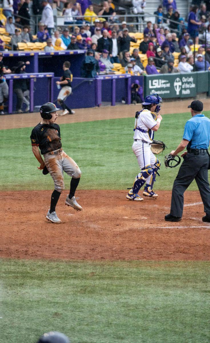 VMI baseball redshirt senior pitcher Trey Morgan (1) celebrates after scoring a run during LSU's 11-8 win against VMI on Friday, Feb. 16, 2024, at Alex Box Stadium in Baton Rouge, La.