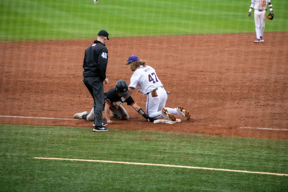 LSU baseball junior third baseman Tommy White (47) tags a VMI player out at third base during LSU's 11-8 win against VMI on Friday, Feb. 16, 2024, at Alex Box Stadium in Baton Rouge, La.