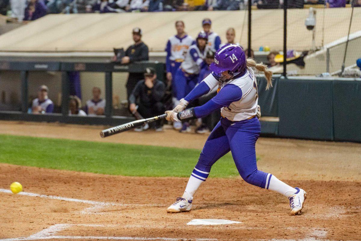 LSU softball graduate student infielder Karli Petty (14) connects with the ball Thursday, Feb. 8, 2024, during LSU&#8217;s 8-0 win against Nicholls at Tiger Park in Baton Rouge, La.