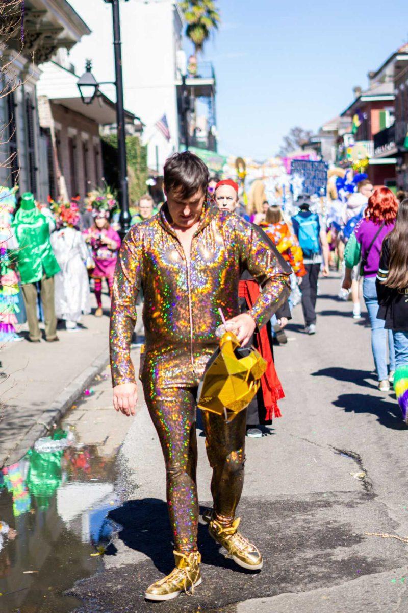 A golden man walks Tuesday, Feb. 13, 2024, on Bourbon Street in New Orleans, La.