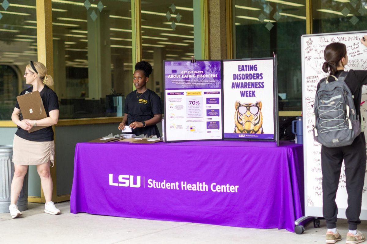 A student writes on the board Wednesday, Feb. 28, 2024, in front of the LSU Library in Baton Rouge, La.