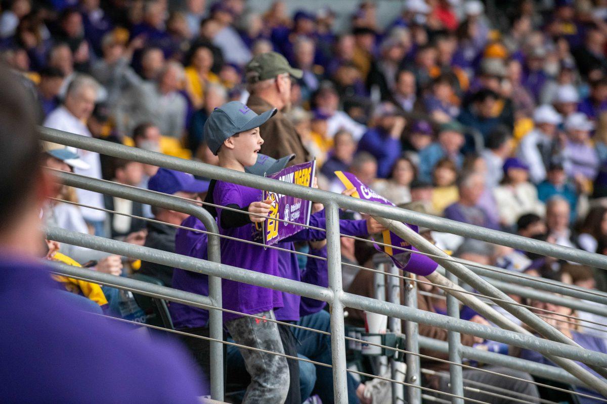 A young fan waves his sign around in support of the team during LSU's 11-8 win against VMI on Friday, Feb. 16, 2024, at Alex Box Stadium in Baton Rouge, La.