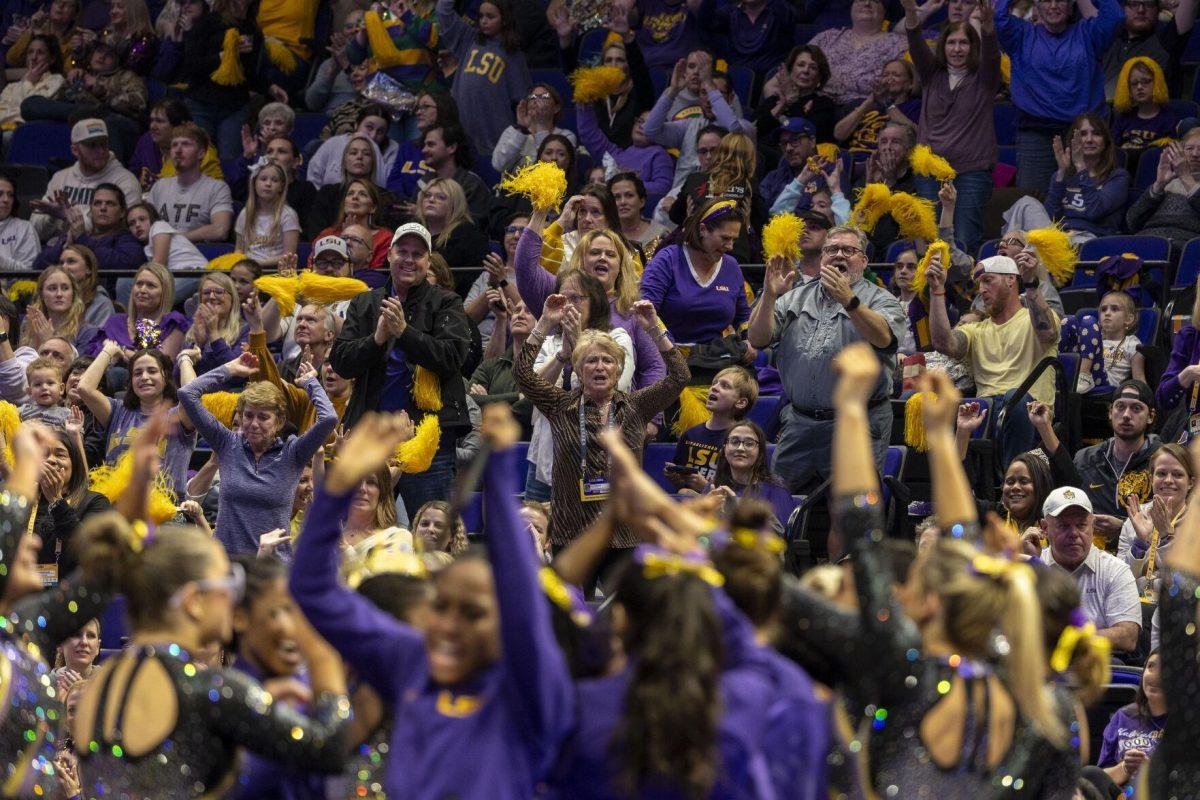 Former LSU gymnastics head coach D-D Breaux celebrates fifth-year all-around Kiya Johnson's balance beam routine Friday, Feb. 16, 2024, during LSU's win 198.300-197.10 against Auburn in the Pete Maravich Assembly Center.