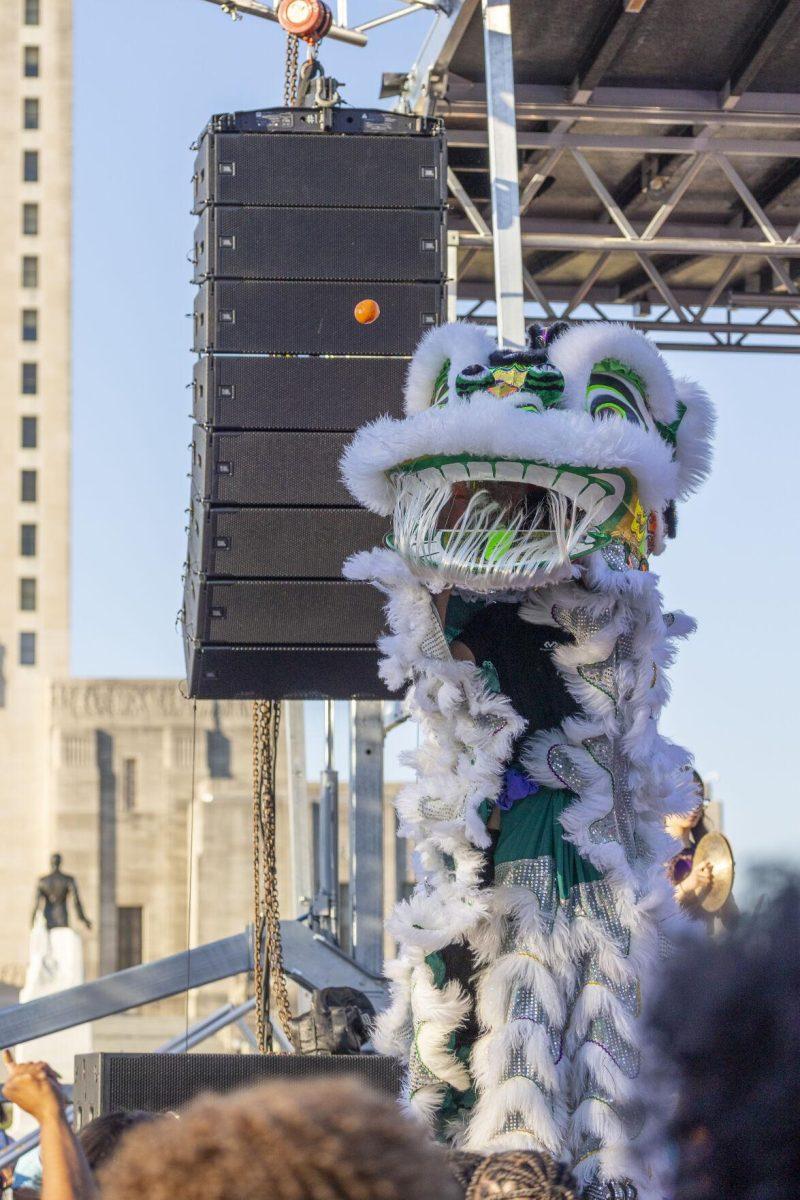 A Southern Lotus lion launches an orange into the crowd Sunday, Feb. 25, 2024, during the second annual 225Fest 2024 at 660 N. Fourth St. in Baton Rouge, La.