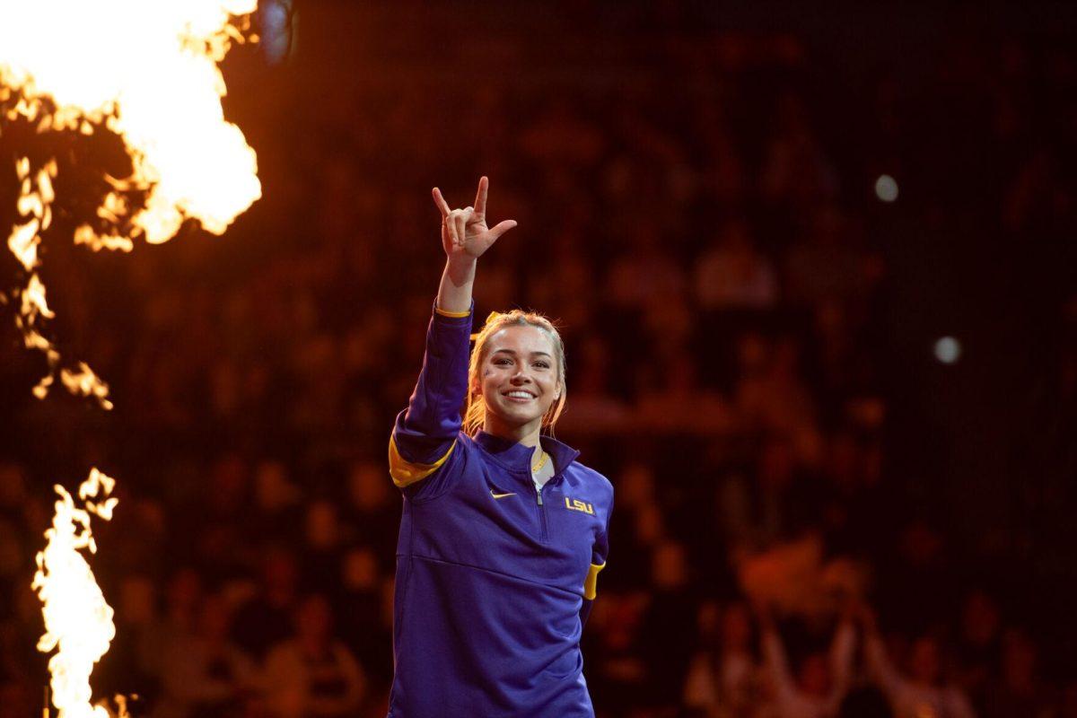 LSU gymnastics all-around senior Olivia Dunne makes a rock-and-roll sign Friday, Feb. 2, 2024, before LSU&#8217;s 198.475-196.200 win against Arkansas at the Pete Maravich Assembly Center in Baton Rouge, La.