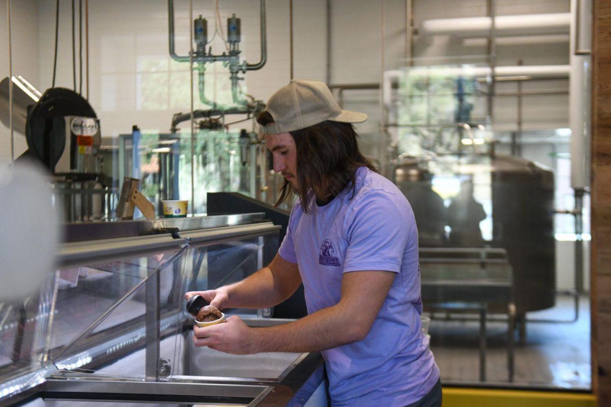 LSU information systems and decision sciences sophomore Tyler Besse scoops ice cream at the new Dairy Store location Tuesday, Feb. 20, 2024, on S. Campus Dr. on LSU&#8217;s campus in Baton Rouge, La.